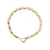 Pulsera de oro amarillo 18K con diseño y circonitas